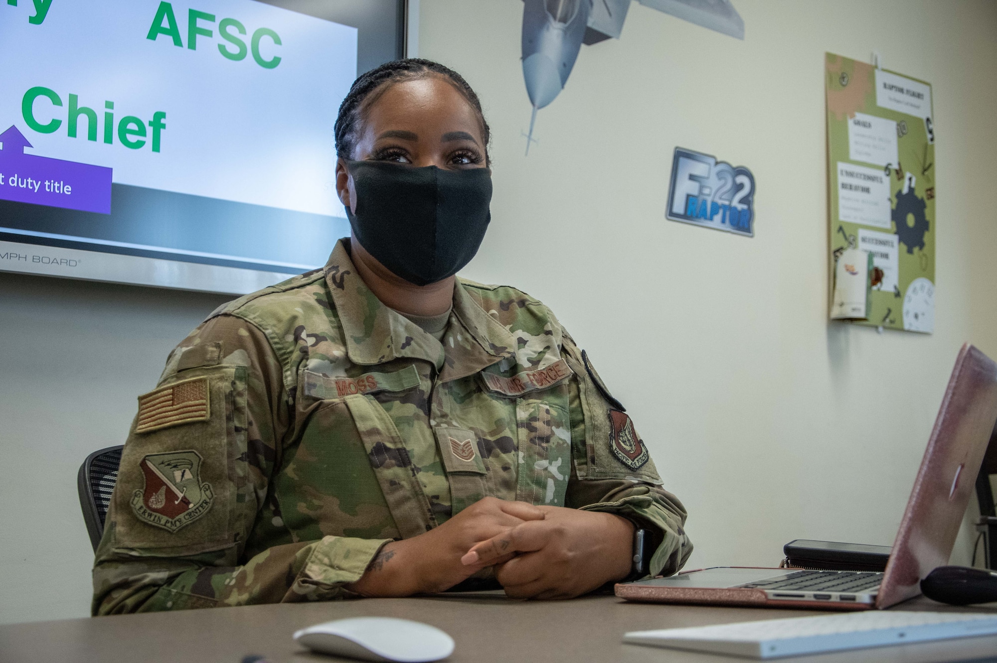 Airman listens to her students.