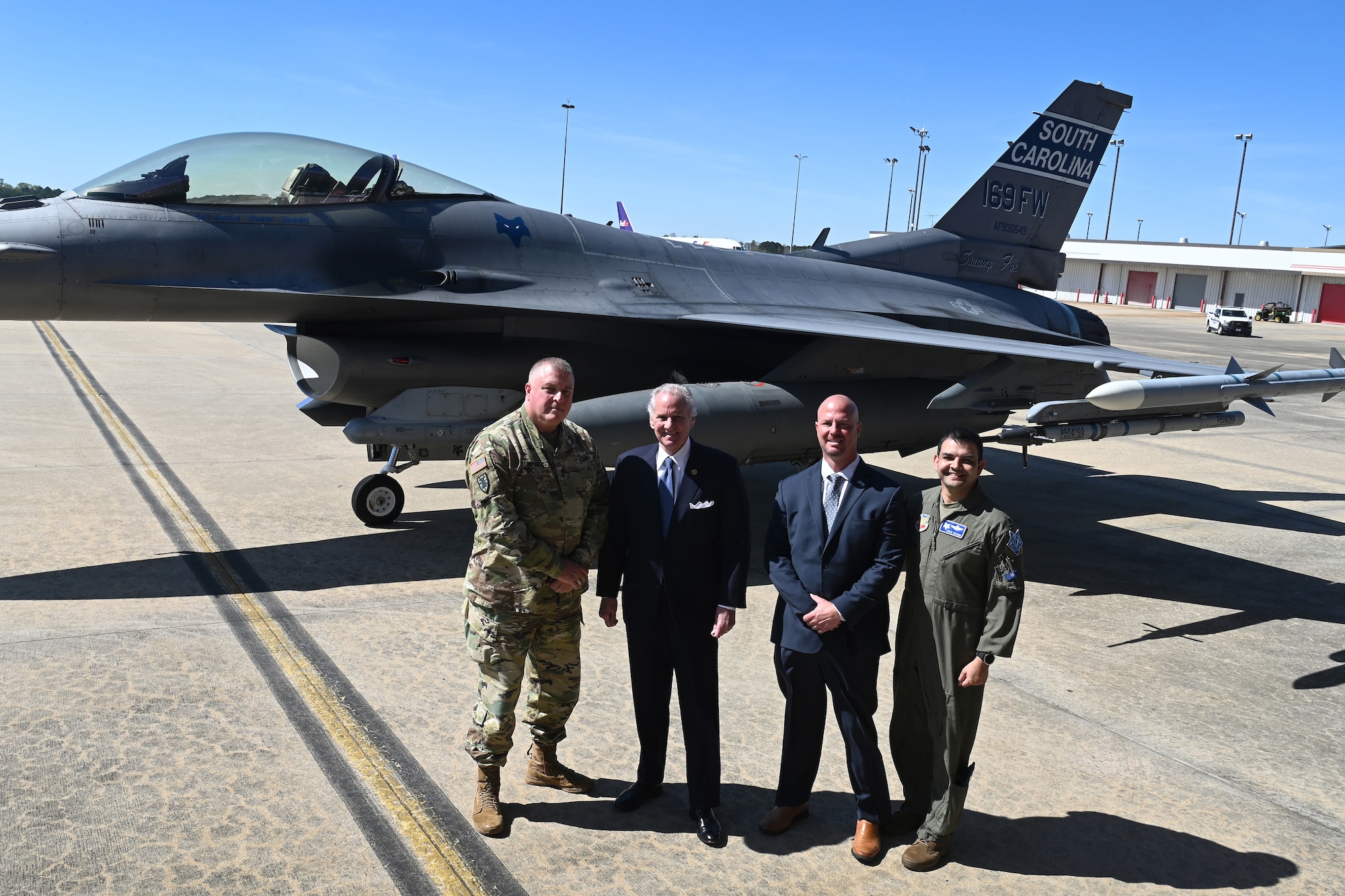 South Carolina Governor Henry McMaster, center-left, U.S. Army Maj. Gen. Van McCarty, left, The Adjutant General of South Carolina, U.S. Air Force Col. Quaid Quadri, far right, 169th Fighter Wing Commander, and Mike Gula, center-right, Executive Director at Columbia Metropolitan Airport, pose for a photo in front of the South Carolina Air National Guard's flagship F-16 fighter jet at Columbia Metropolitan Airport, March 21, 2022. Columbia Metropolitan Airport hosts a press conference to announce a six-month temporary move of F-16 fighter jet flying operations from the the South Carolina Air National Guard's 169th Fighter Wing at nearby McEntire Joint National Guard Base to their airport in Columbia, South Carolina. This joint partnership, regarding the temporary relocation of F-16 aircraft, will begin in April 2022. Speaking during the press conference are South Carolina Governor Henry McMaster; U.S. Army Maj. Gen. Van McCarty, The Adjutant General of South Carolina; U.S. Air Force Col. Quaid Quadri, 169th Fighter Wing Commander; and Mike Gula Executive Director at Columbia Metropolitan Airport.  (U.S. Air National Guard photo by Senior Master Sgt. Edward Snyder, 169th Fighter Wing)
