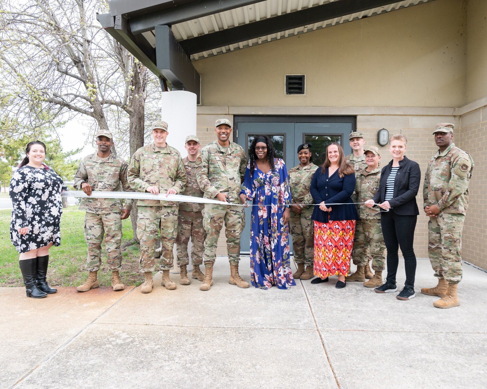Members of the First Sergeants Council and Dover Spouses Club cut a ribbon at the Airman’s Attic on Dover Air Force Base, Delaware, March 23, 2022. The Dover Spouses club will now oversee all operations at the Airman’s Attic which offers Team Dover Airmen and their families free household items, food and uniforms. (U.S. Air Force photo by Mauricio Campino)