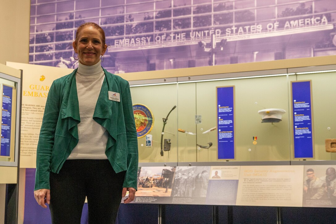 Christina Johnson, Marine Veteran and project manager for the National Museum of the Marine Corps, stands in front of the Marine Corps Embassy Security Guard section of the museum in Triangle, Va. Johnson's role as project manager is to ensure that the team meets deadlines for events and exhibits currently being constructed. (Marine Corps photo by Lance Cpl. Jennifer Sanchez)