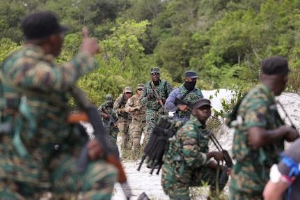 Guyana Defense Force (GDF) personnel and Florida Army National Guard Soldiers with B/2-54th Security Force Assistance Brigade (SFAB) assess security tactics during a knowledge exchange at Base Camp Stephenson, Guyana, March 22, 2022. Guyana and the Florida Guard have been partners under the National Guard Bureau's State Partnership Program since 2003.