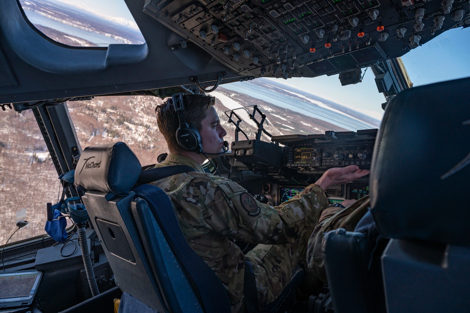 U.S. Air Force Capt. Taylor Williams, left, and U.S. Air Force Capt. Michael Cooper, both pilots with the 8th Airlift Squadron, fly over the Alaska Range, Alaska, March 21, 2022, during Exercise Rainer War 22A. The exercise is designed to demonstrate the 62nd Airlift wing’s ability to operate and survive while defeating challenges to the U.S. military advantage in all operating domains – air, land, sea and cyberspace. (U.S. Air Force photo by Airman 1st Class Charles Casner)