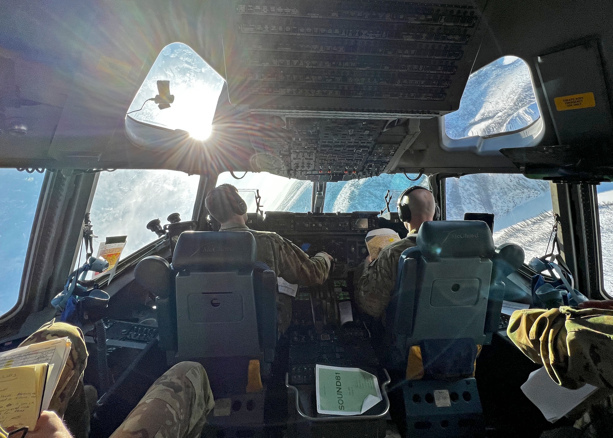 U.S. Air Force Capt. Ben Basham, left, and Capt. Dan Wold, both pilots with the 8th Airlift Squadron, fly a low-level simulated airdrop in a C-17 Globemaster III for Exercise Rainier War 22A at Joint Base Elmendorf-Richardson, Alaska, March 23, 2022. Rainier War is a semi-annual, large readiness exercise led by the 62nd Airlift Wing. It is designed to train aircrews under realistic scenarios that support a full spectrum readiness operations against modern threats and replicate today’s contingency operations. (U.S. Air Force photo by Airman 1st Class Callie Norton)
