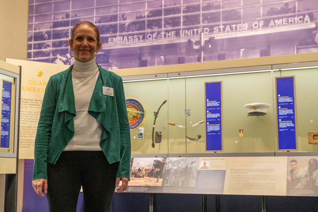 Christina Johnson, Marine Veteran and project manager for the National Museum of the Marine Corps, stands in front of the Marine Corps Embassy Security Guard section of the museum in Triangle, Va. Johnson's role as project manager is to ensure that the team meets deadlines for events and exhibits currently being constructed.