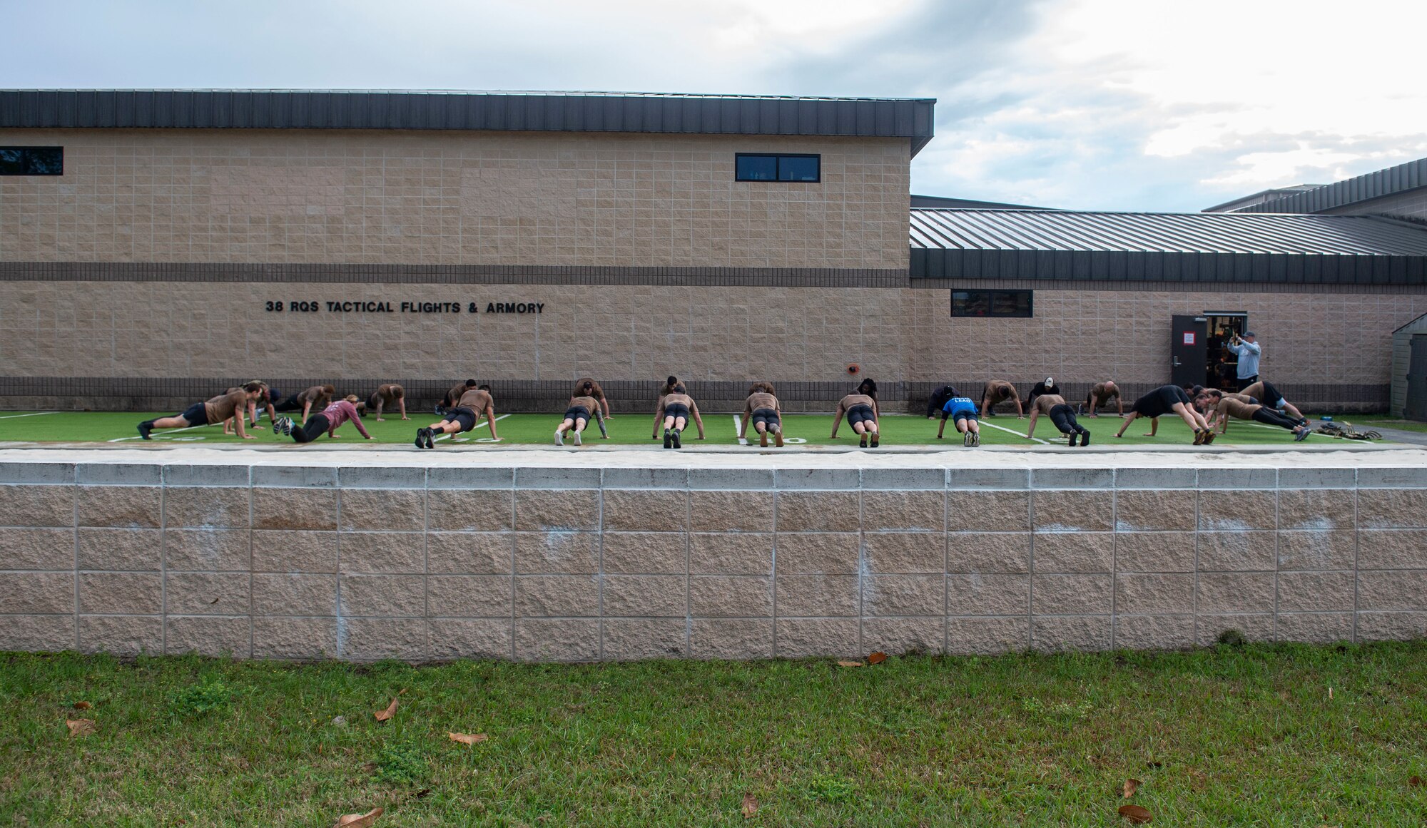 A photo of people doing push-ups.
