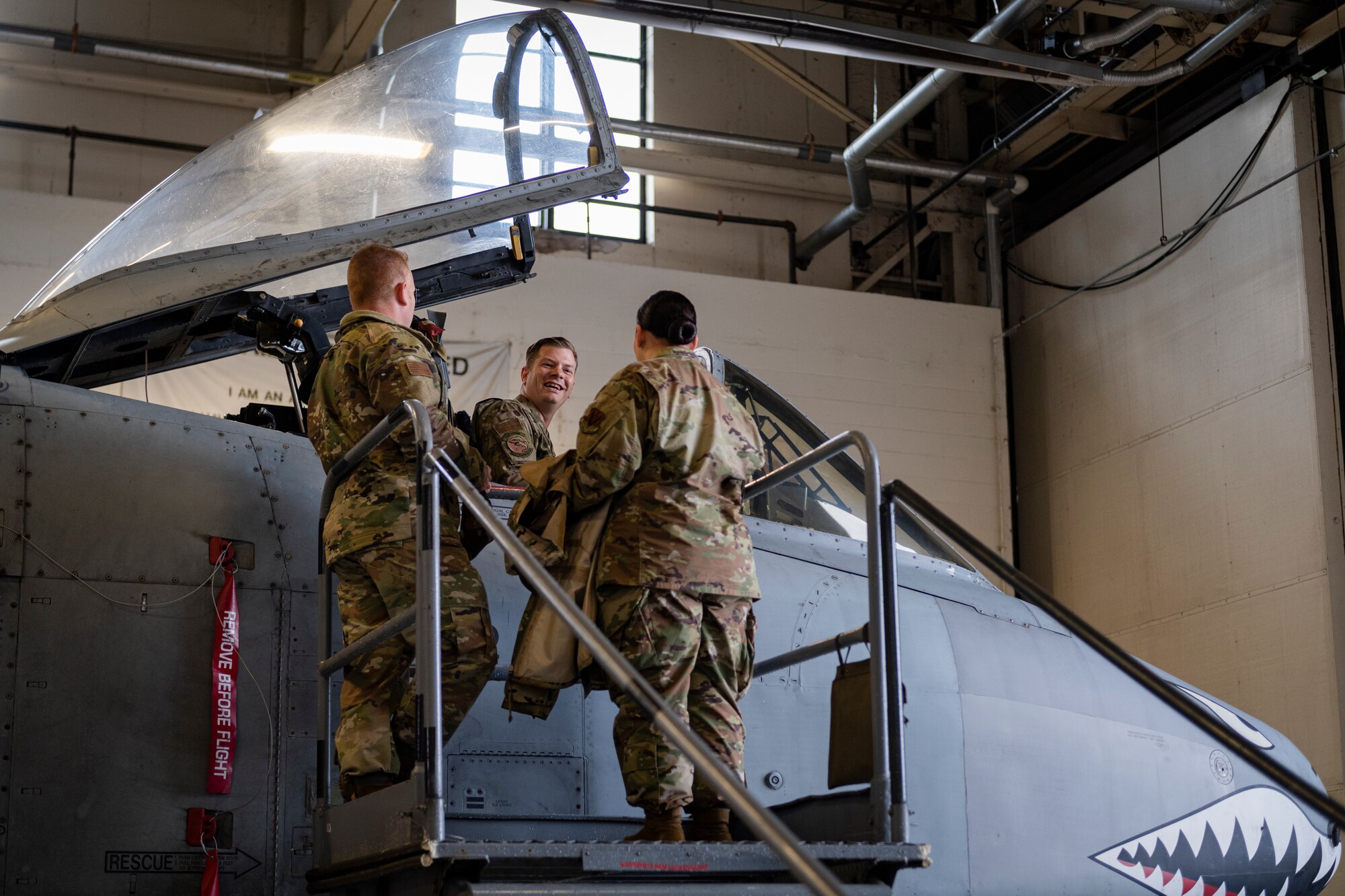 Photo of an Airman showing Flying Tiger University students a cockpit of an A-10C Thunderbolt II