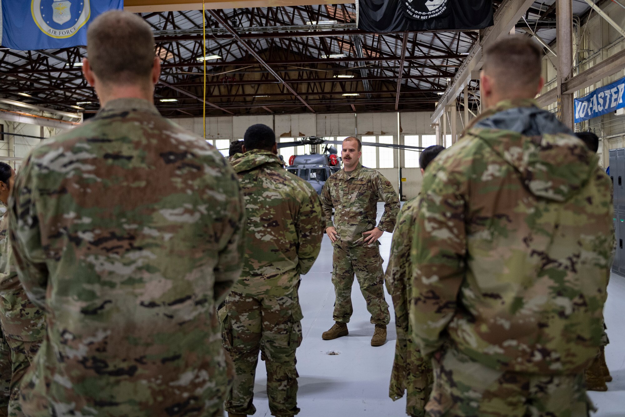 Photo of an Airman explaining rescue missions