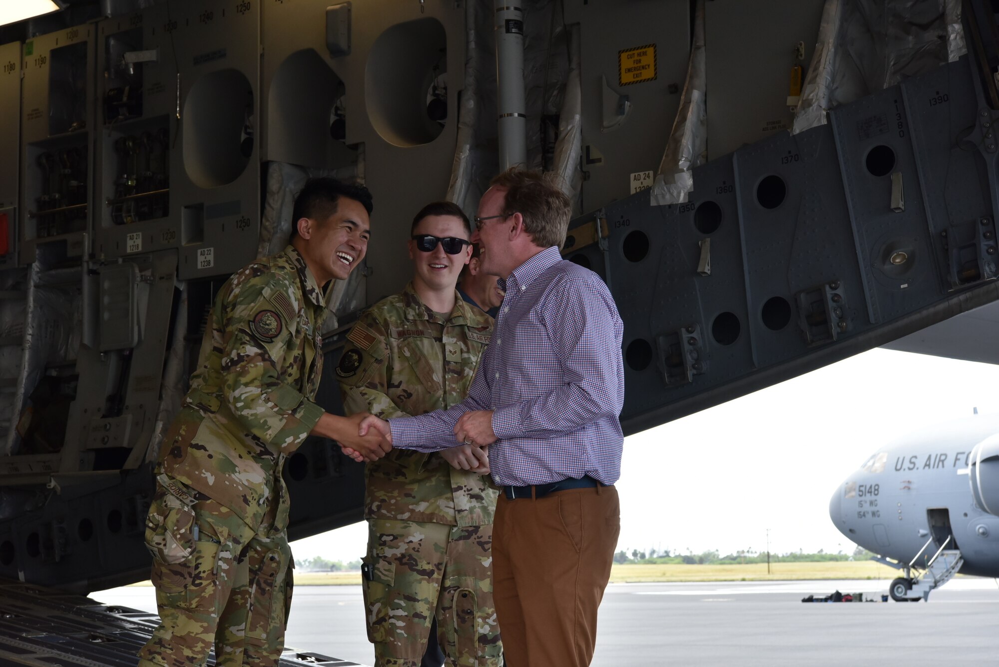 1st Lt. Ralph Andrew Carios, 535th Airlift Squadron pilot, receives a challenge coin from Taylor Fravel, Massachusetts Institute of Technology Security Studies Program Arthur and Ruth Sloan professor of Political Science director, during a base tour at Joint Base Pearl Harbor-Hickam, Hawaii, March 23, 2022. Students toured a C-17 Globemaster III static display and met with Air Force crew members to learn more about the aircraft’s mission and the Airmen it takes to get the mission done. (U.S. Air Force photo by 1st Lt. Benjamin Aronson)