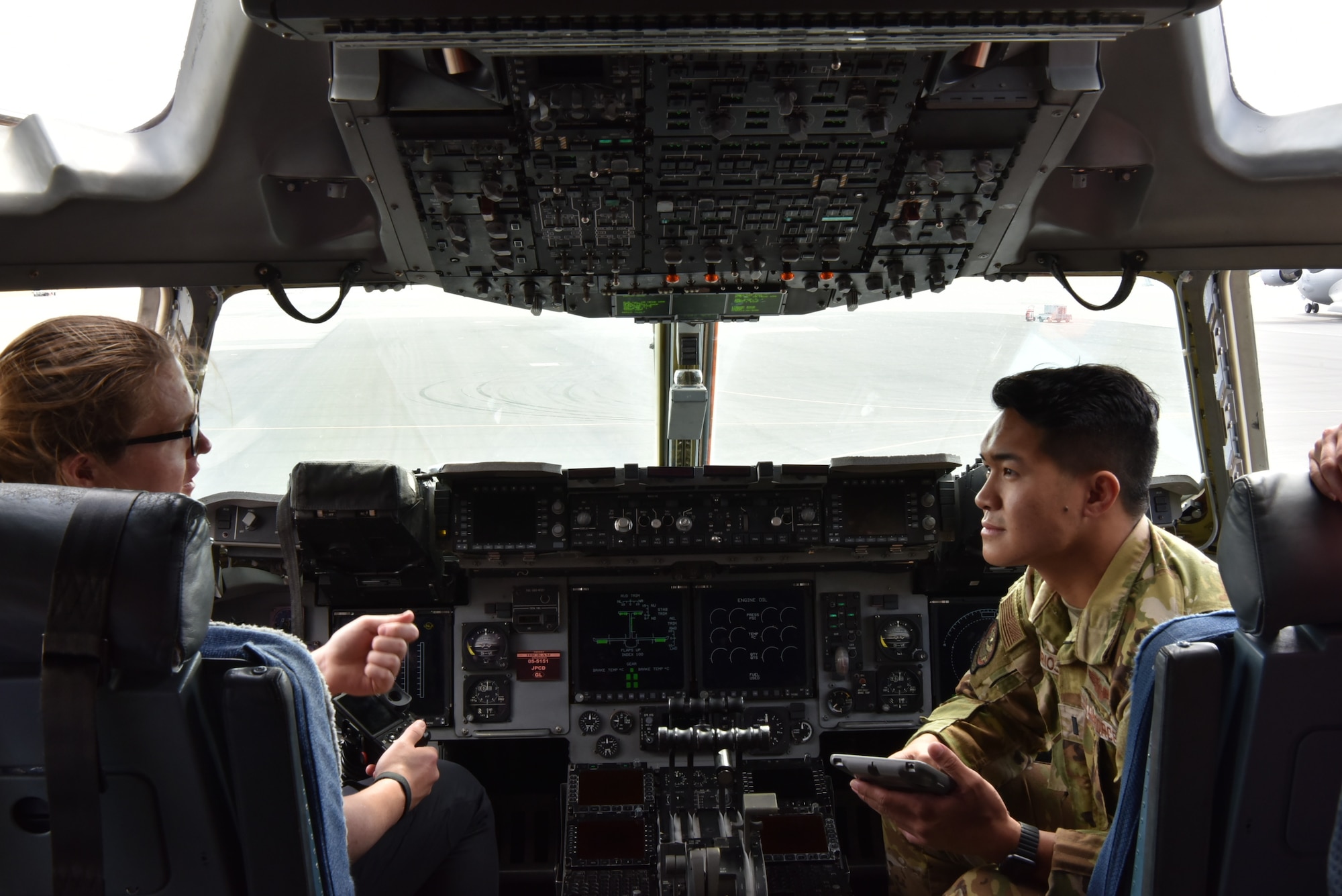 A student from the Massachusetts Institute of Technology Security Studies Program talks with 1st Lt. Ralph Andrew Carios, 535th Airlift Squadron pilot, about the role of the 535th AS in the Air Force’s mission at Joint Base Pearl Harbor-Hickam, Hawaii, March 23, 2022. Students visited JBPHH as part of a tour of military commands on the island of Oahu to learn about the Department of Defense’s role in ensuring a free and open Indo-Pacific. (U.S. Air Force photo by 1st Lt. Benjamin Aronson)