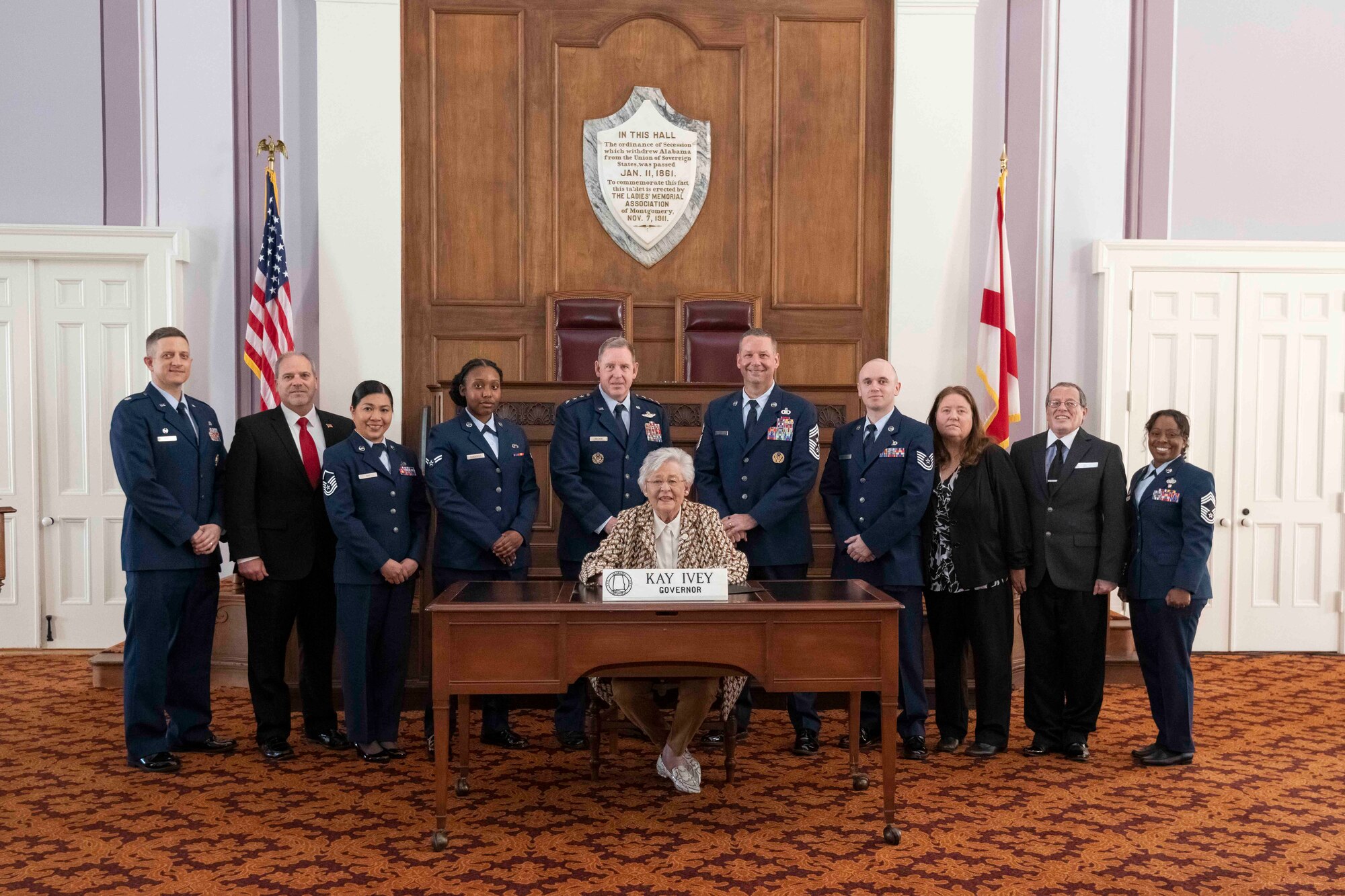 Maxwell AFB, Ala. - Air Force leaders Lt Gen James B. Hecker, Lieutenant Colonel Kevin Pond, Chief Master Sergeant Randy Kwiatkowski, Chief Master Sergeant Alexius Reid, MSgt Ellainne Bay, TSgt Brian Haga, A1C Allison Ganapamo, Mr. JR Breeding and Dr. Donald Ellwood celebrate the Community College of the Air Force 50th Anniversary with Governor of Alabama Kay Ivey proclamation signing at the State Capitol in the Old House Chamber on 28 Feb 2022. (US Air Force photo by Cassandra Cornwell)