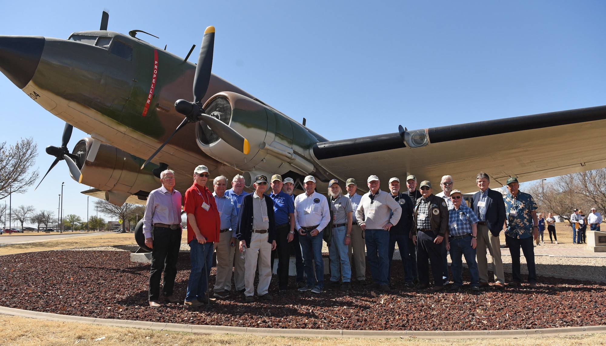 Family members of retired Chief Master Sgt. Paul. W. Weyandt and retired Lt. Col. David H. Eddy, pose for a picture after the dedication of the Weyandt-Eddy Memorial Plaza at Goodfellow Air Force Base, Texas, March 25, 2022. Weyandt and Eddy were EC-47 crew members who served during the Vietnam War. (U.S. Air Force photo by Senior Airman Abbey Rieves)