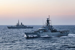 The Royal Saudi Naval Force frigate Makkah (814), back, and the guided-missile destroyer USS Winston S. Churchill (DDG 81), not pictured, provide overwatch as the Royal Bahrain Naval Force patrol warship Al Zubara transits the Bab el-Mandeb Strait, Nov. 20. The International Maritime Security Construct (IMSC) maintains the freedom of navigation, international law and free flow of commerce to support regional stability and security of the maritime commons.