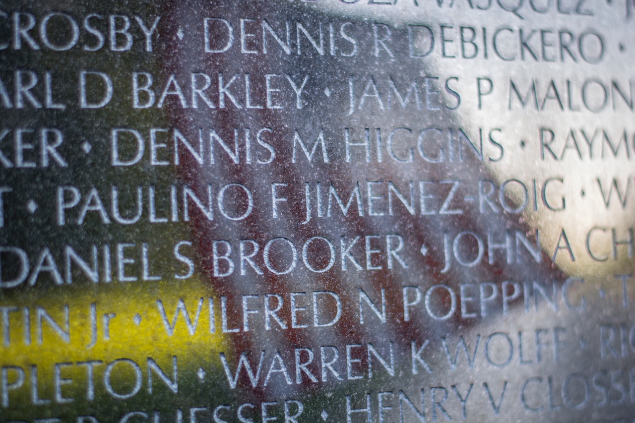 American flag reflected in Vietnam Veterans Memorial wall.