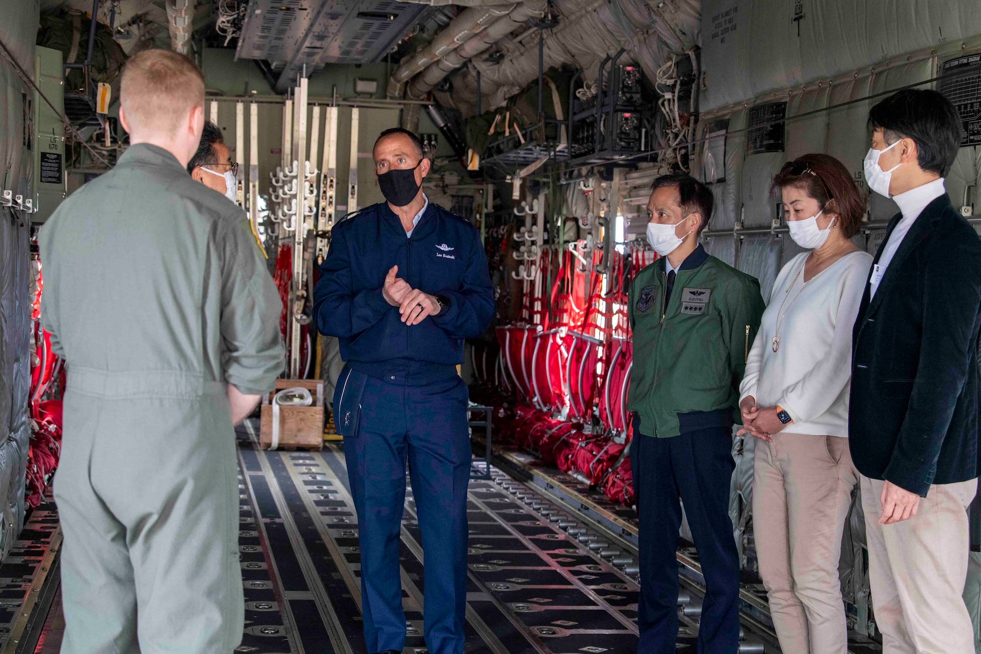 Maj. Gen. Leonard Kosinski, center, 5th Air Force deputy commander, discuss the importance of the C-130J Super Hercules mission with crew during a community outreach tour at Yokota Air Base, Japan, March 19, 2022.