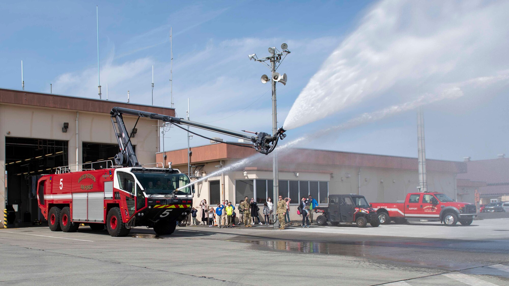 Firefighters from the 374th Civil Engineer Squadron test a firetruck’s water cannons for a tour group during a community outreach event at Yokota Air Base, Japan, Mar. 19, 2022.