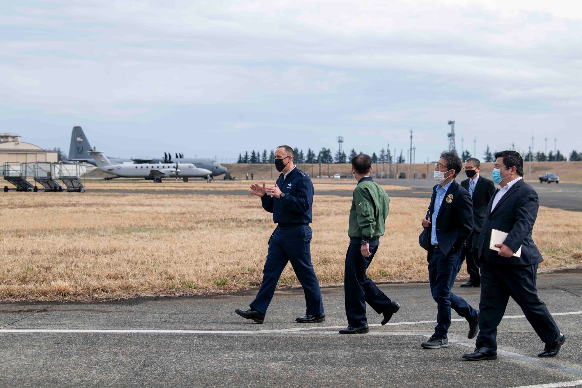 Maj. Gen. Leonard Kosinski, left, 5th Air Force deputy commander, explains the importance of the assigned aircraft to Gen. Shunji Izutsu, center, Japan Air Self-Defense Force (Koku-Jietai) Chief of Staff, during a community outreach tour at Yokota Air Base, Japan, March 19, 2022.