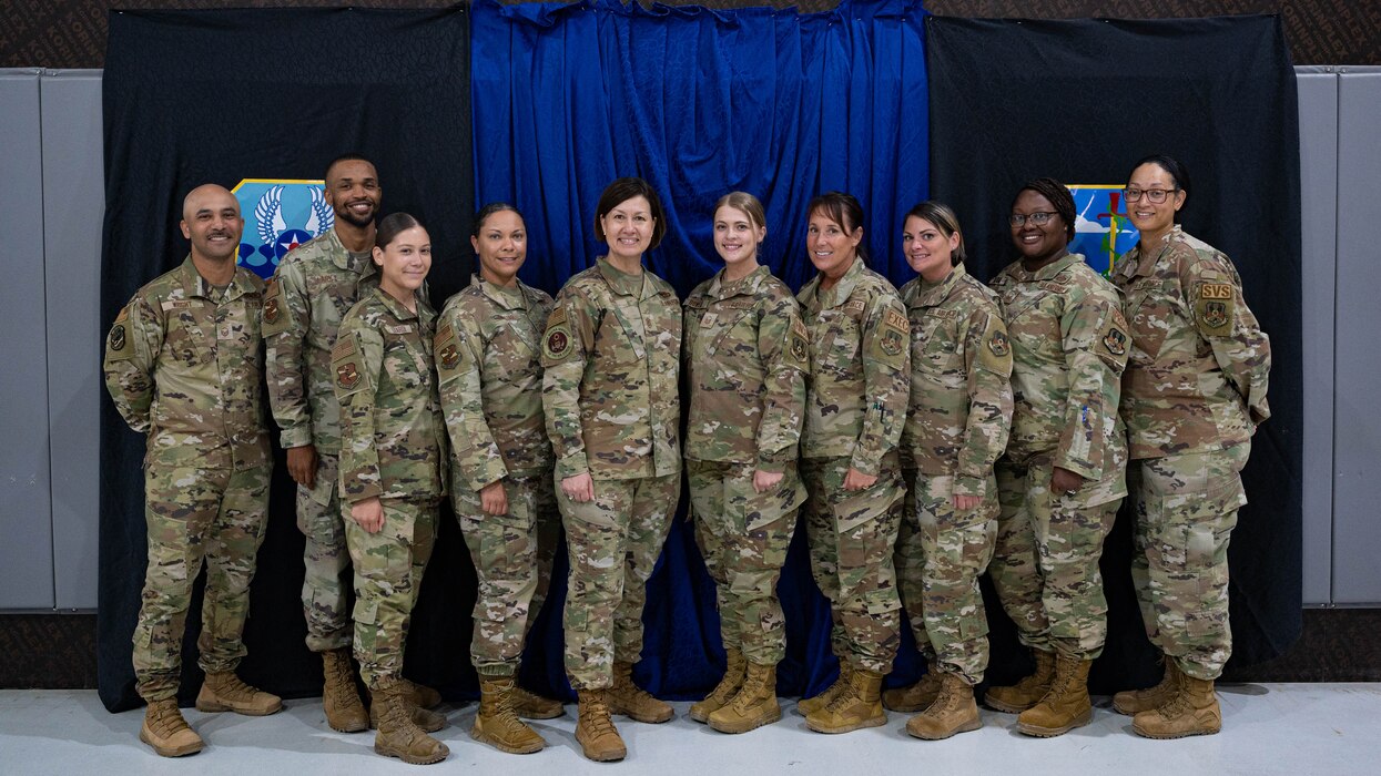 Chief Master Sgt. of the Air Force JoAnne S. Bass poses with 380th Air Expeditionary Wing Airmen during her visit to Al Dhafra Air Base, United Arab Emirates, March 24, 2022.