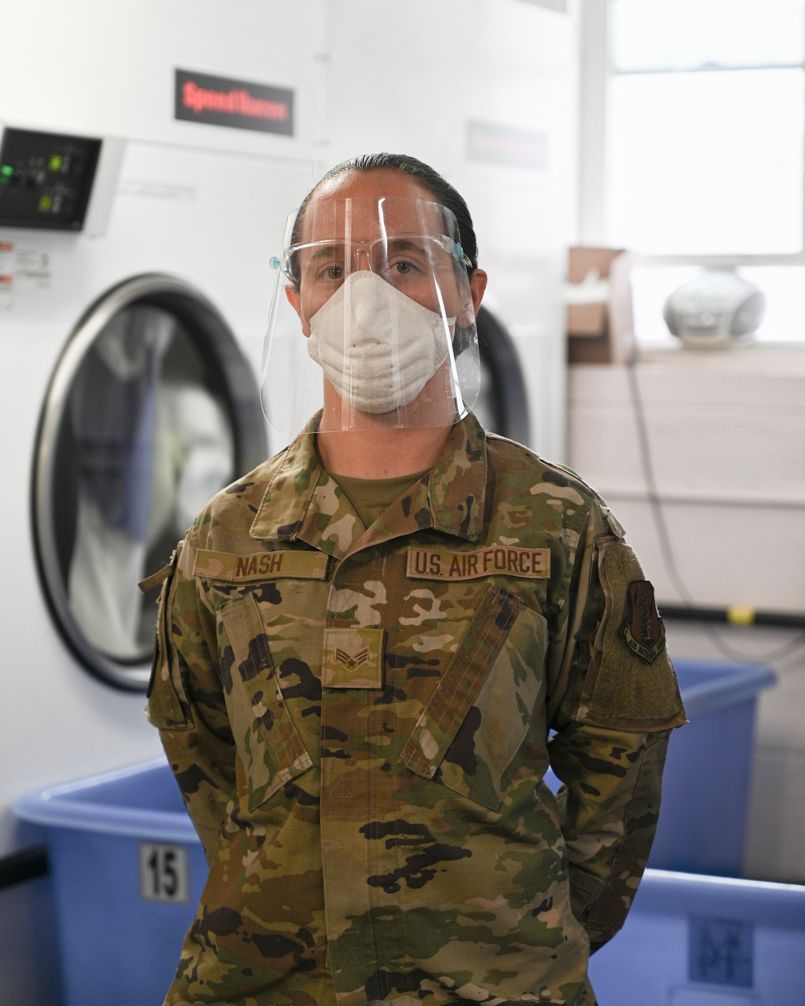 Senior airman Jessica Nash stands in washing room.