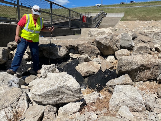 Kansas City District, U.S. Army Corps of Engineers Civil Engineer Susan Abbott inspects displaced riprap around the Rathbun Dam stilling basin during the Rathbun annual dam safety inspection in Aug. 2020 at Rathbun Lake, Iowa.