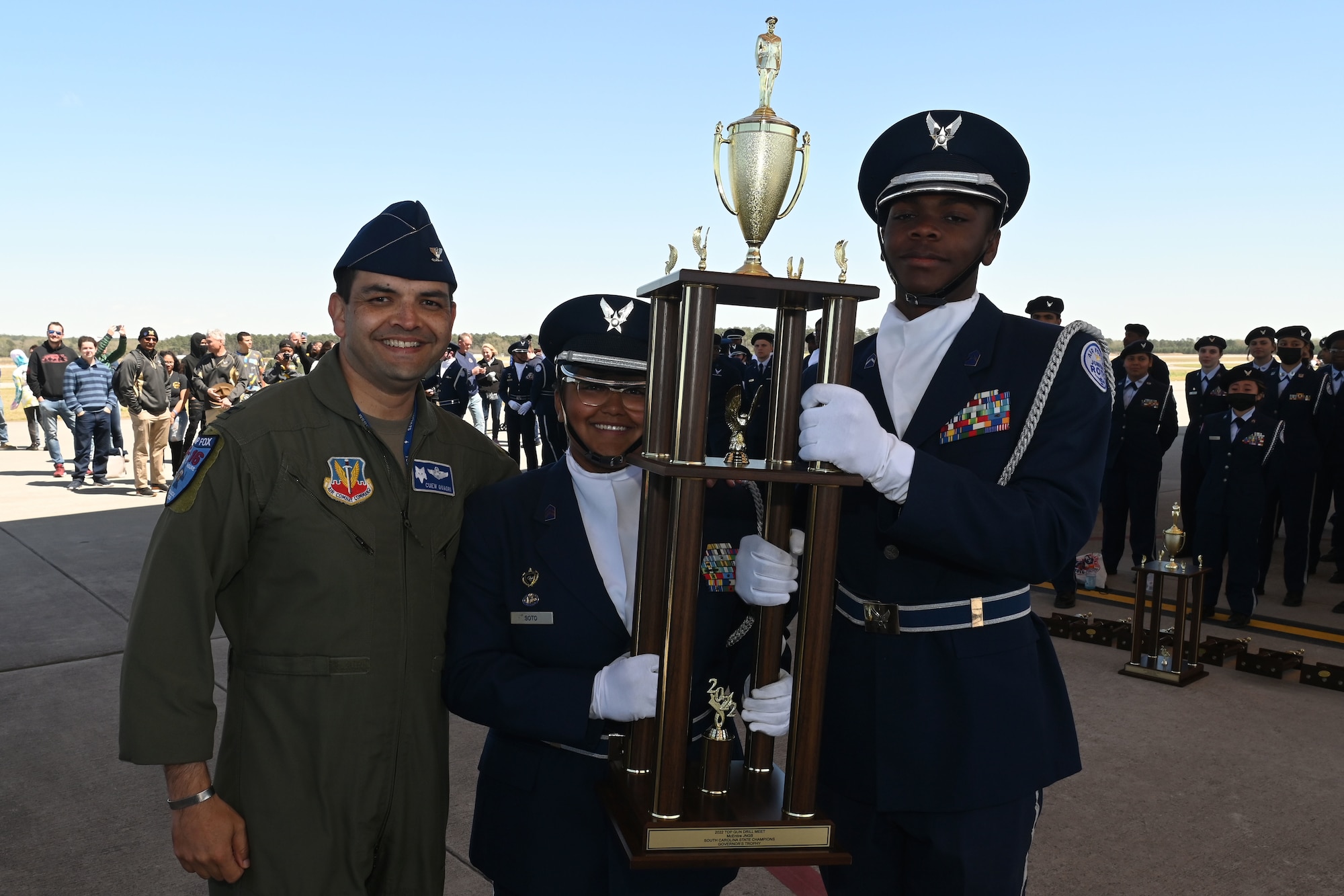 U.S. Air Force Col. Quaid Quadri, 169th Fighter Wing commander, presents the second overall trophy for the competition to Spring Valley High School during the annual Top Gun Drill Meet at McEntire Joint National Guard Base, South Carolina, March 26, 2022. High School Junior Reserve Officers Training Corps cadets from twenty high schools from across the state competed in twelve drill and ceremony events sponsored by the South Carolina Air National Guard. (U.S. Air National Guard photo by Senior Master Sgt. Edward Snyder)