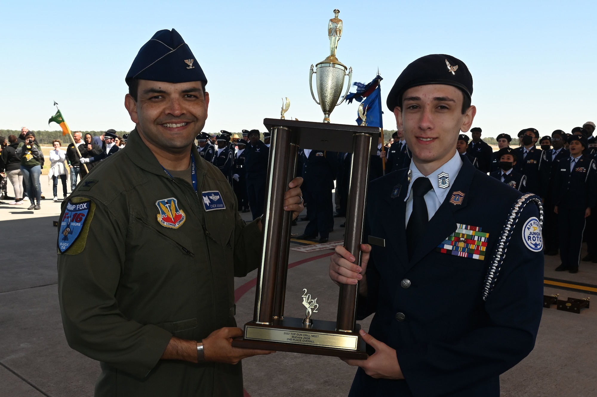 U.S. Air Force Col. Quaid Quadri, 169th Fighter Wing commander, presents the second overall trophy for the competition to Fort Dorchester High School during the annual Top Gun Drill Meet at McEntire Joint National Guard Base, South Carolina, March 26, 2022. High School Junior Reserve Officers Training Corps cadets from twenty high schools from across the state competed in twelve drill and ceremony events sponsored by the South Carolina Air National Guard. (U.S. Air National Guard photo by Senior Master Sgt. Edward Snyder)