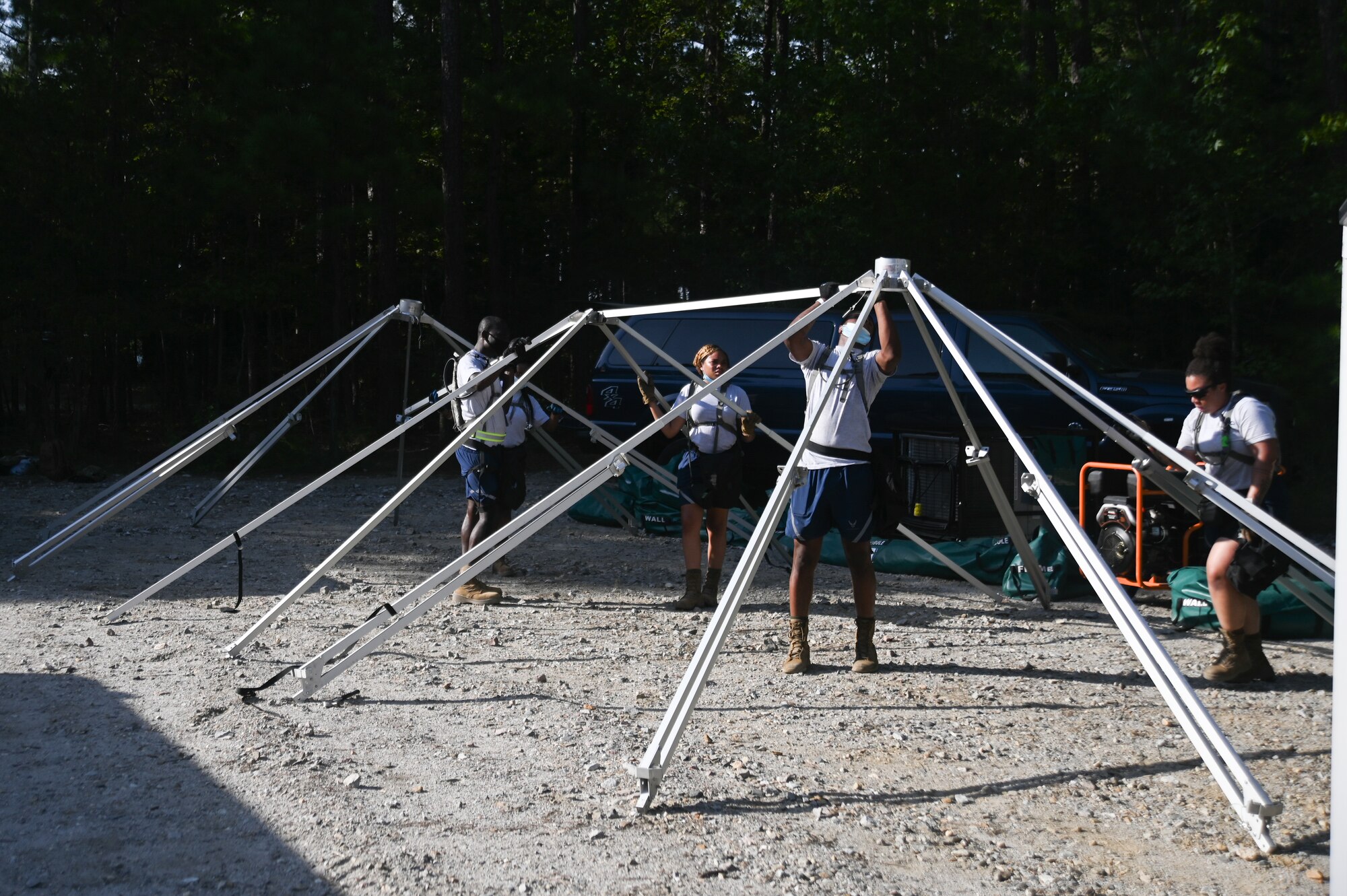 National Guardsmen assigned to the 113th Fatality Search and Recovery Team, D.C. Air National Guard, put up a tent during the Chemical Biological Radiological Nuclear Emergency Response Force Package pre-evaluation and training at the Fort Pickett Maneuver Training Center in Blackstone, Virginia, Aug. 27, 2021. (U.S. Air National Guard photo by Airman 1st Class Daira Jackson)