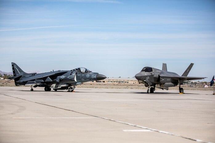 An AV-8B Harrier and an F-35B Lightning II are staged during the change of command and redesignation ceremony for Marine Fighter Attack Squadron 214 aboard Marine Corps Air Station Yuma, Arizona, March, 25, 2022. As part of the transition from the AV-8B Harrier to the F-35B Lightning II, Marine Attack Squadron 214 was re-designated as VMFA-214. The F-35B Lightning II is replacing the AV-8B Harrier to introduce unmatched capabilities to the Marine Corps. The F-35B Lightning II represents a leap forward in air dominance by providing the operational agility and tactical supremacy Marines need to provide expeditious and lethal support.