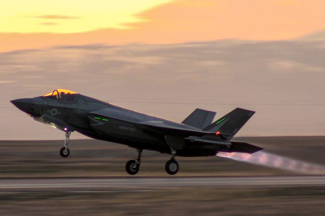 An aircraft takes off near mountains.