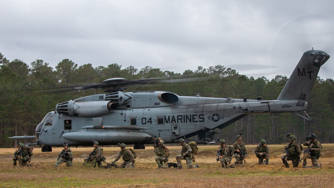Dutch Marines with Marine Squadron Carib, Netherlands Marine Corps, set security on a CH-53E Super Stallion during Exercise Caribbean Urban Warrior on Camp Lejeune, North Carolina, March 23, 2022. The exercise is a bilateral training evolution designed to increase global interoperability between 2d Reconnaissance Battalion, 2d Marine Division, and Marine Squadron Carib. (U.S. Marine Corps photo by Lance Cpl. Ryan Ramsammy)
