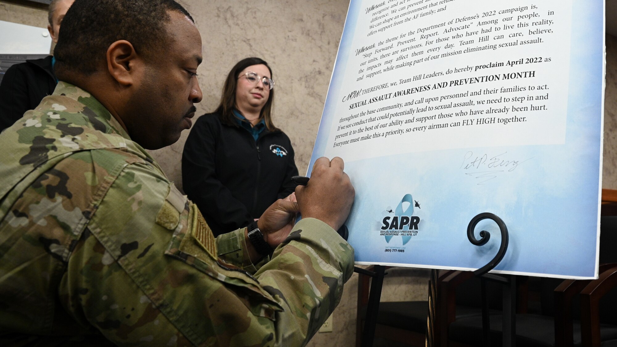 Chief Master Sgt. Raymond Riley, 75th Air Base Wing command chief, signs the Sexual Assualt Awareness and Prevention Month (SAAPM) proclamation at Hill Air Force Base.