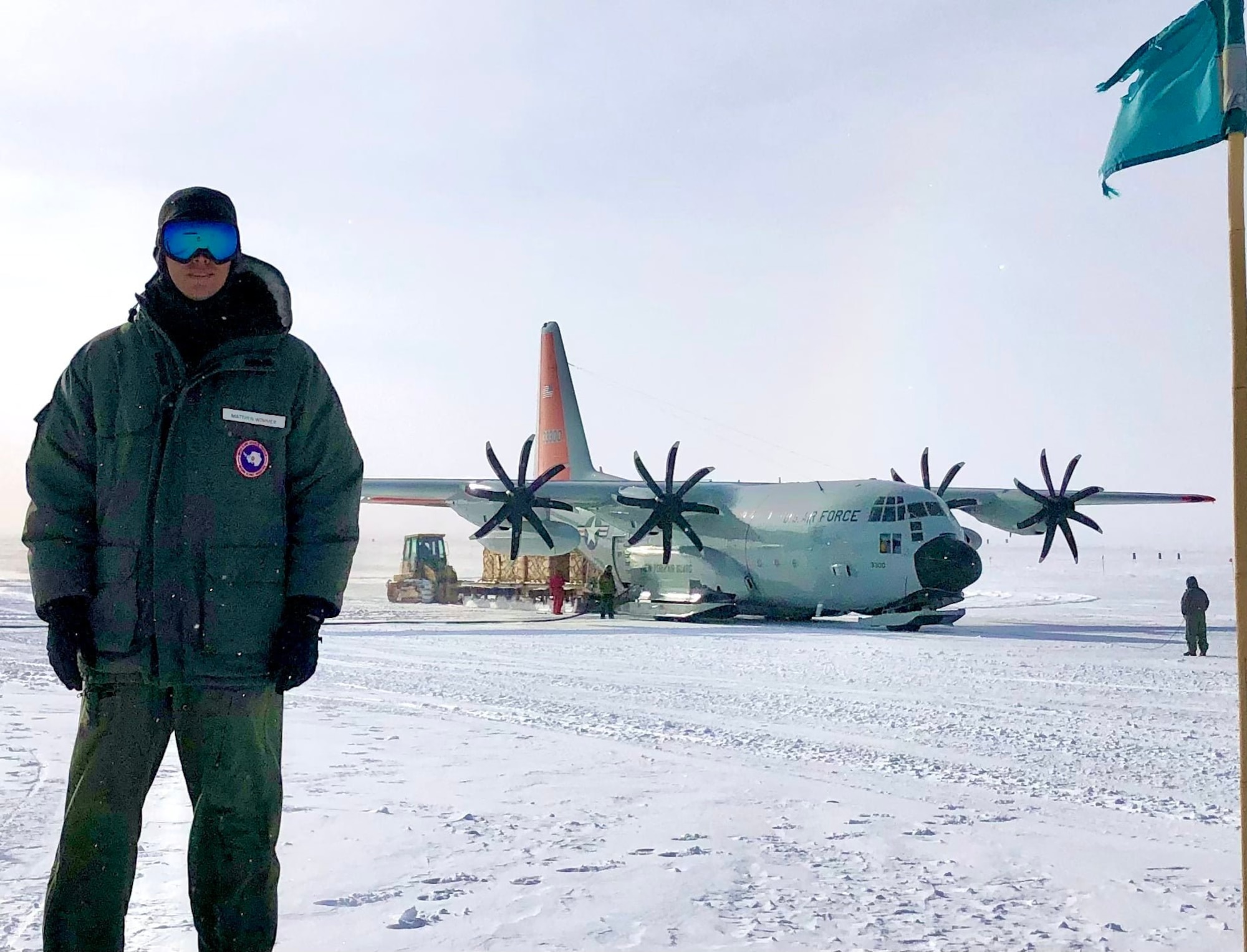 U.S. Air Force Maj. Matthew Wimmer, 56th Operations Group flight surgeon, poses for photo in front of an LC-130 aircraft on the flightline of Amundson-Scott South Pole station, Antarctica, in 2021.