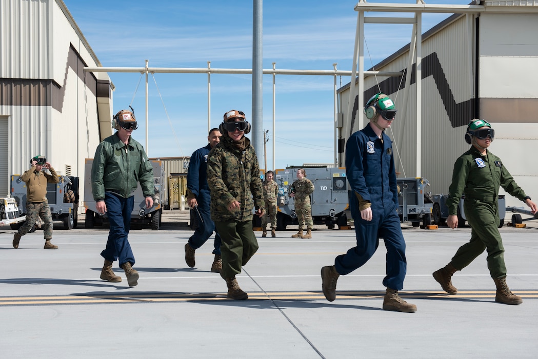 Marines walk on a flight line at Mountain Home Air Force Base.