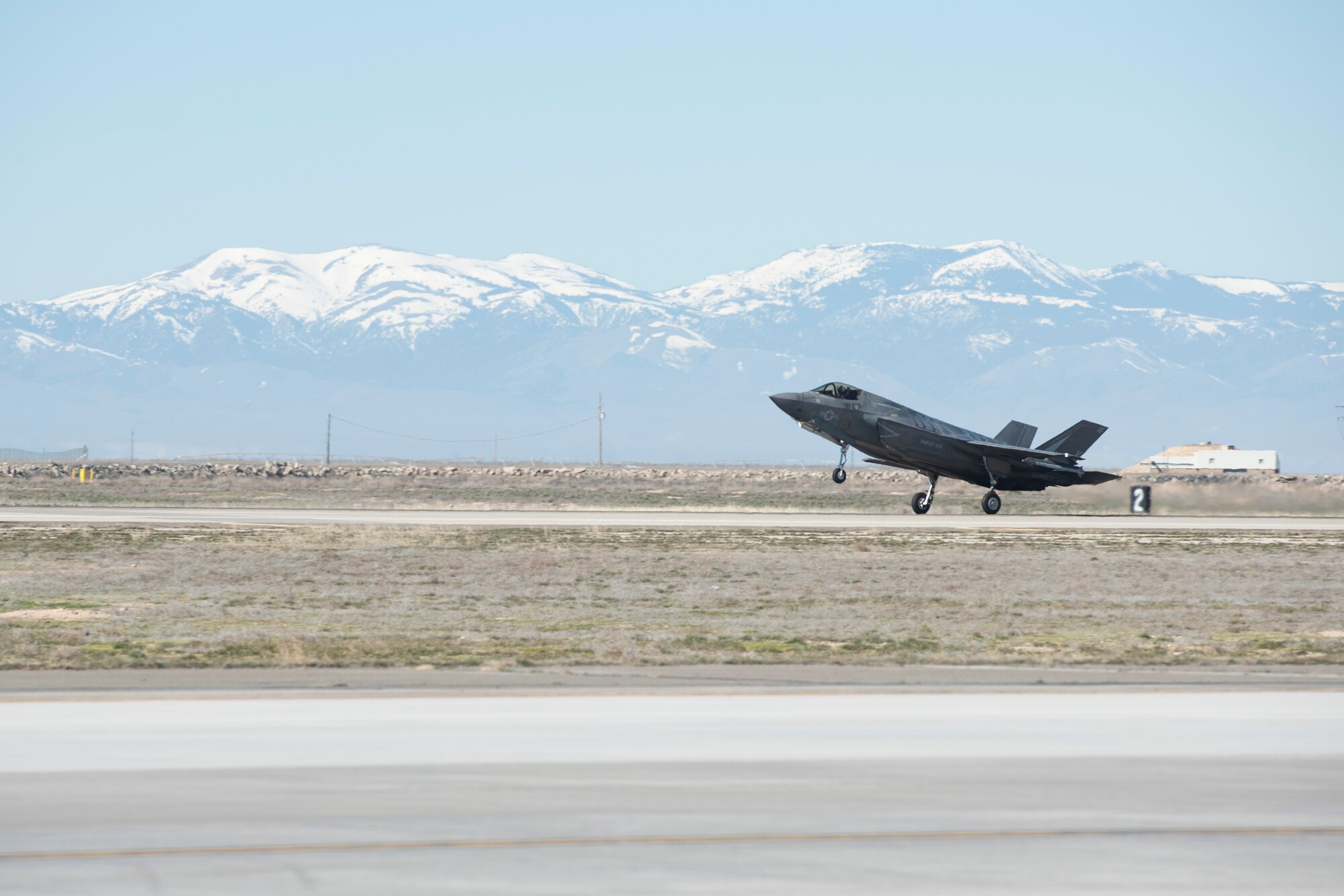 An F-35B Lightning II fighter jet lands on the Mountain Home Air Force Base flight line.