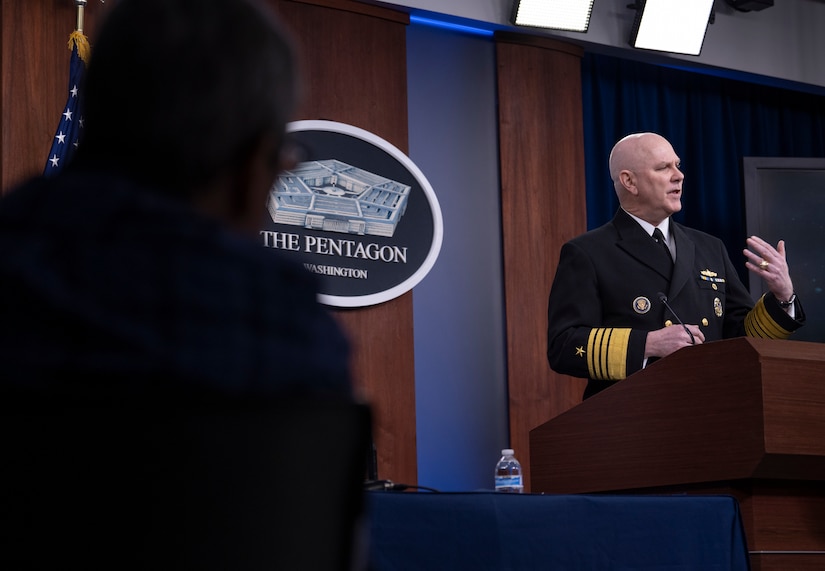 A man speaks from a lectern.