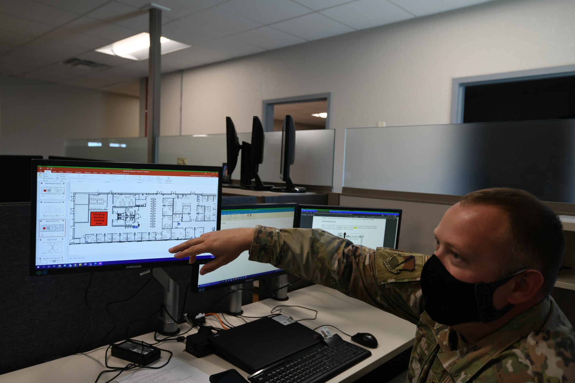 man points at computer screen