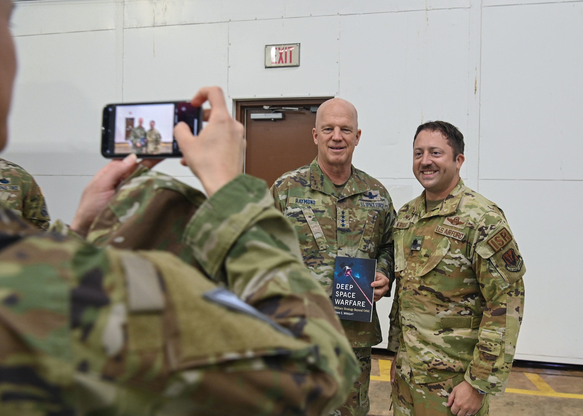 U.S. Space Force Gen. John W. “Jay” Raymond, Chief of Space Operations, takes a photo with U.S. Air Force Lt. Col. John Wright, commander of the 4th Reconnaissance Squadron at Andersen Air Force Base, Guam, during a tour March 26, 2022.  During his visit, Raymond met with U.S. Air Force Brig. Gen. Jeremy Sloane, commander of the 36th Wing, received a mission brief, toured the 21st Space Operations Squadron, Detachment 2, and shared lunch with the Airmen, 12 Guardians assigned here and their spouses. (U.S. Air Force photo by Staff Sgt. Aubree Owens)