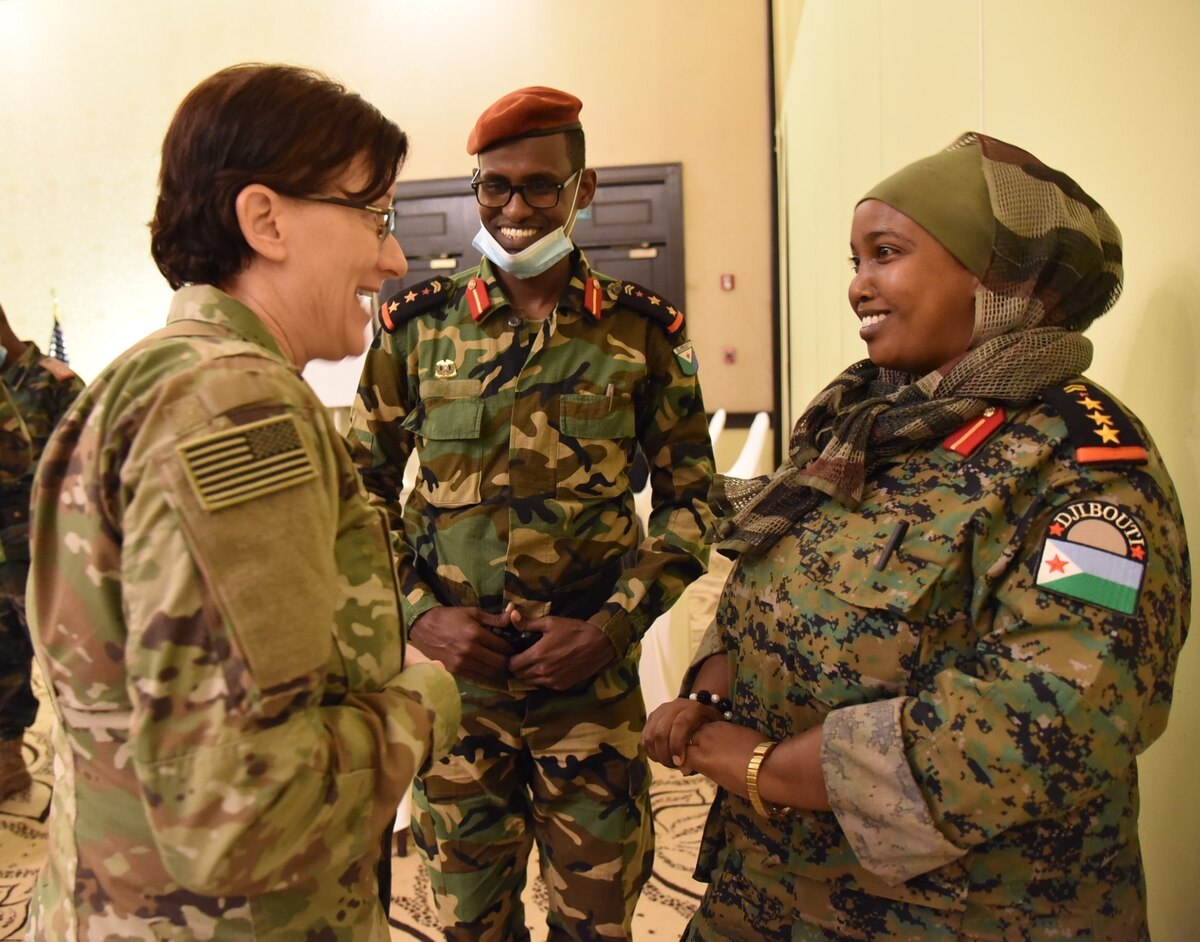 Army 1st Sgt. Marissa Lowe, left, the senior human resources noncommissioned officer with the Kentucky Army National Guard’s 63rd Theater Aviation Brigade, talks with a female Djiboutian officer during a State Partnership Program planning conference at Kempinski Palace, Djibouti City, Djibouti, March 8, 2022.