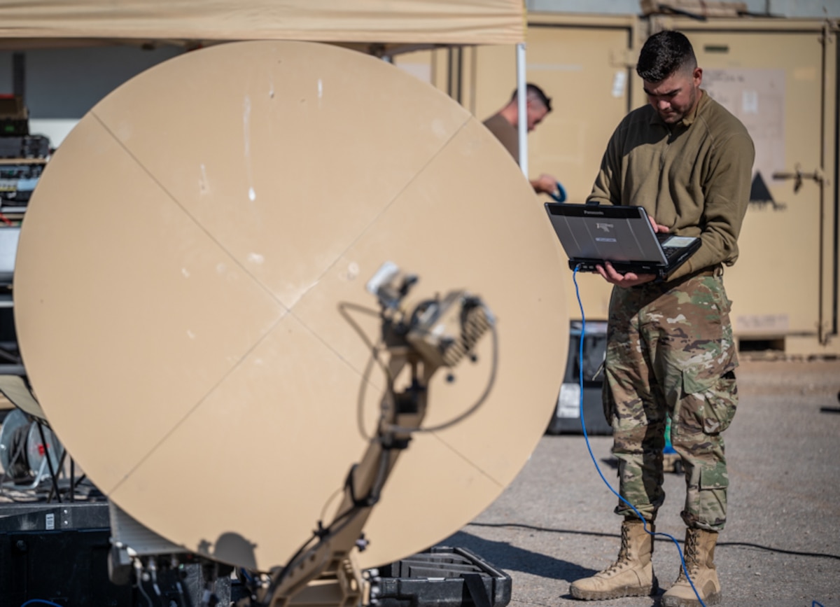 Airman First Class John Winkler, 332d Expeditionary Communications Squadron Radio Frequency  transmission technician, performs operational system checks on a Comm Flyaway Kit and a Ranger very small aperture terminal (VSAT) at an undisclosed location in Southwest Asia, March 14, 2022. The 332d ECS provides a broad range of communication services to the 332d AEW workforce to win the fight today as well as tomorrow - building on the Red Tail legacy of excellence. (U.S. Air Force photo by Master Sgt. Christopher Parr)