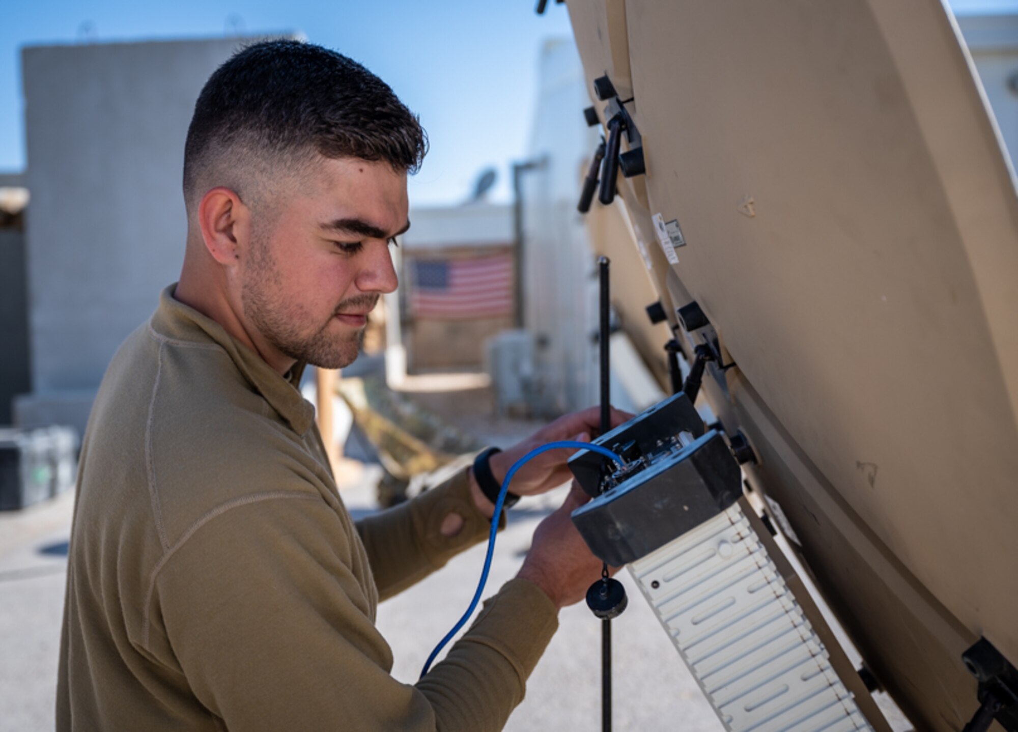 Airman First Class John Winkler, 332d Expeditionary Communications Squadron Radio Frequency  transmission technician, performs operational system checks on a Comm Flyaway Kit and a Ranger very small aperture terminal (VSAT) at an undisclosed location in Southwest Asia, March 14, 2022. The 332d ECS provides a broad range of communication services to the 332d AEW workforce to win the fight today as well as tomorrow - building on the Red Tail legacy of excellence. (U.S. Air Force photo by Master Sgt. Christopher Parr)