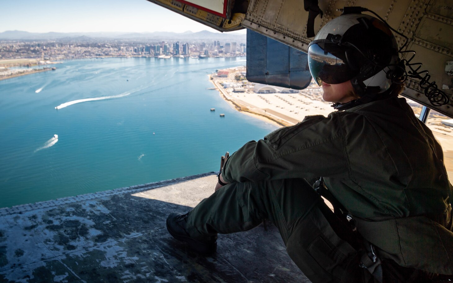 Naval Air Crewman (Mechanical) 2nd Class Erin Cass, a native of Horsham, Pa., assigned to the "Providers" of Fleet Logistics Support Squadron (VRC) 30, observes San Diego from the cargo ramp of a C-2A Greyhound.