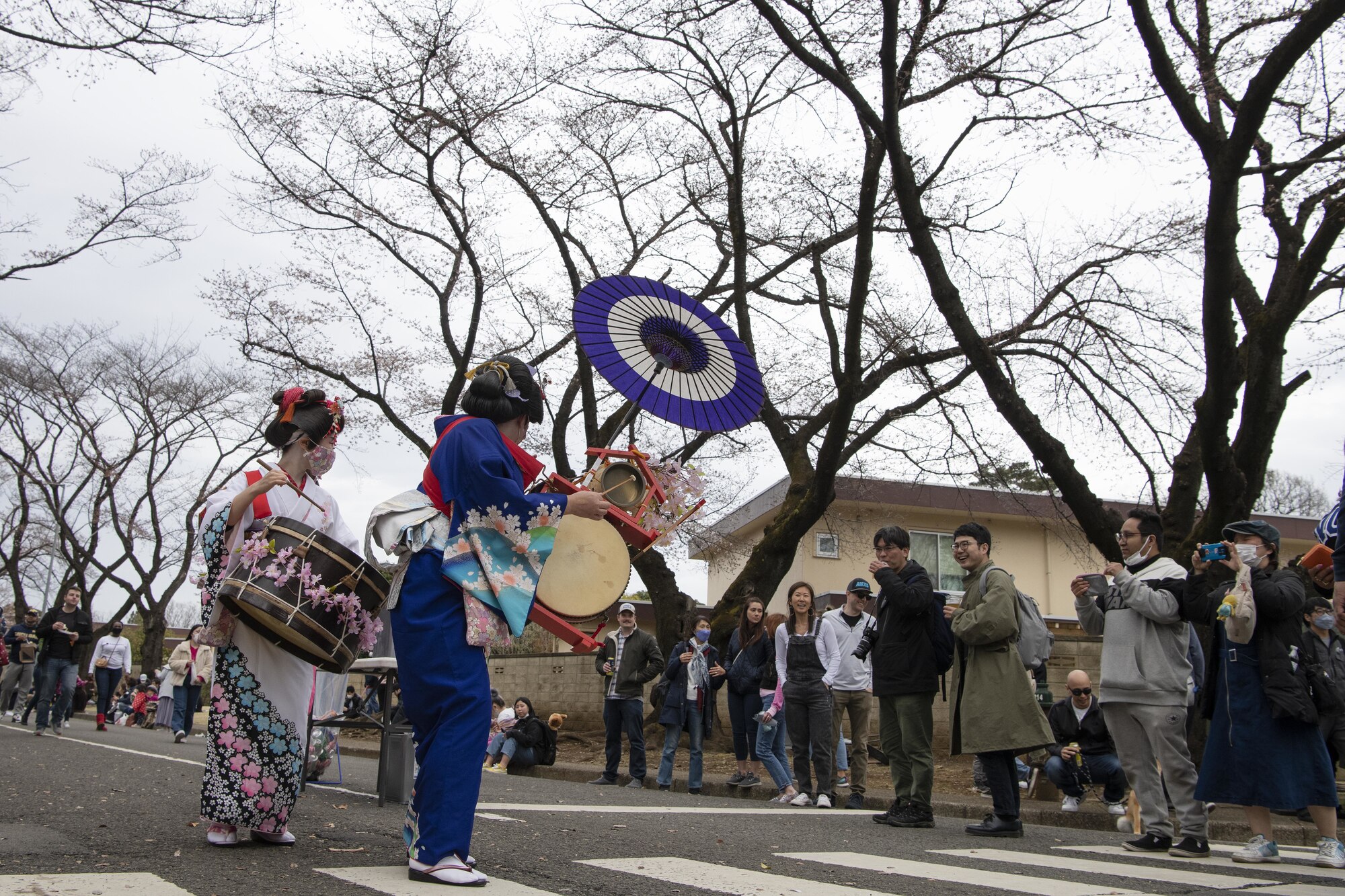Members of the Japanese community and Yokota Air Base interact with a chindon’ya, or Japanese marching band, during the Sakura Spring Festival March 26, 2022, at Yokota Air Base, Japan.