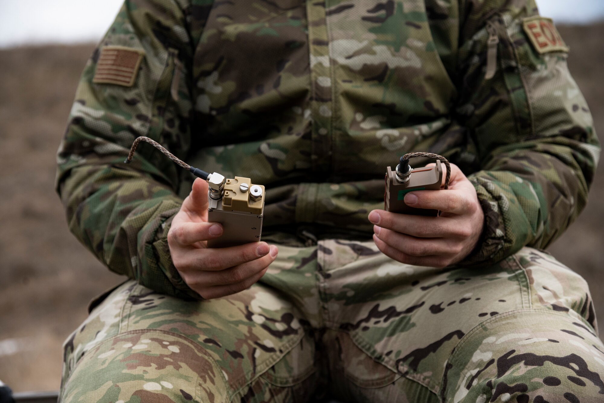 U.S. Air Force Senior Airman Stephen Maloy, 480th Expeditionary Fighter Squadron Explosive Ordnance Disposal technician, sets up a remote detonation device at the 86th Air Base, Romania, March 16, 2022. Using the new innovation technology allows for more C-4 to be saved for other purposes during contingency operations in an austere location. (U.S. Air Force photo by Senior Airman Ali Stewart)