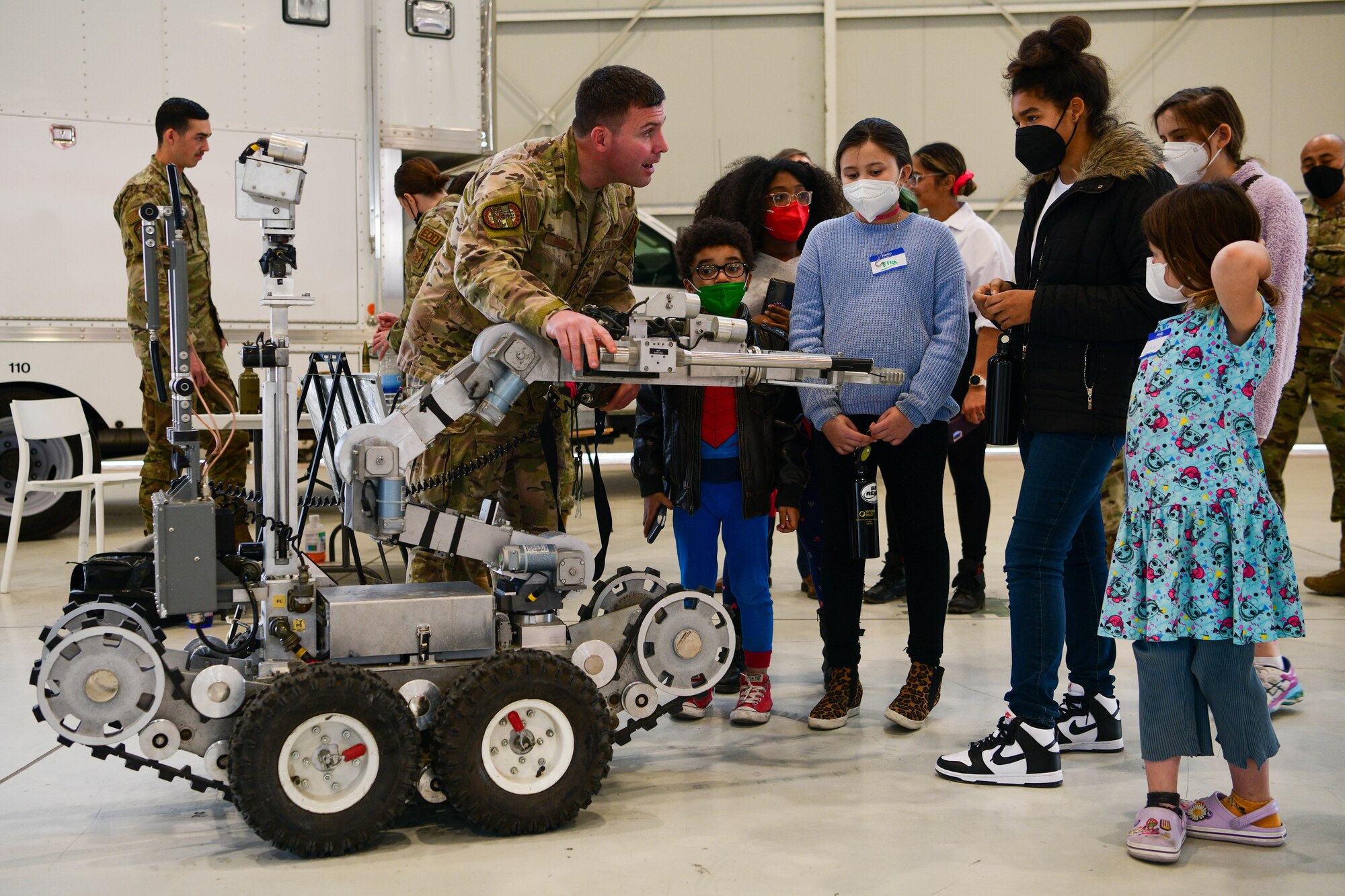 U.S. Air Force Staff Sgt. Jordan Burger, 31st Civil Engineer Squadron Explosive Ordnance Disposal team leader, explains a 31st CES EOD robot’s operations to Wyvern family members at Aviano Air Base, Italy, March 24, 2022. U.S. Air Force Airmen in different 31st CES sections held an immersion with Wyvern families to showcase the operations within their units. The unit trains and prepares combat ready Airmen and equipment to support the combatant commander and Air Expeditionary Force taskings. (U.S. Air Force photo by Senior Airman Brooke Moeder)