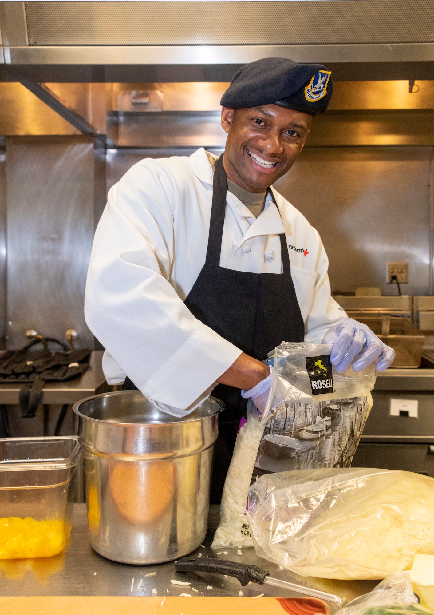 An Airman cooks food