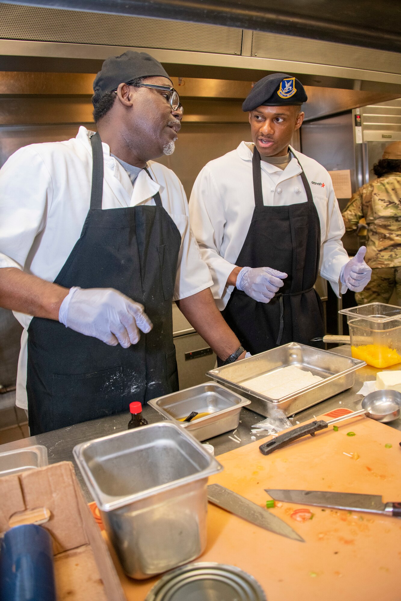 an airman cooks food