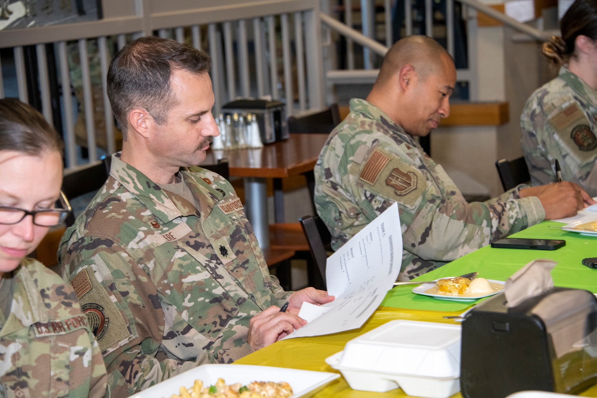 Judges rate the competitors during the chopped challenge at Travis Air Force Base, California, March 23, 2022. The 60th Mission Support Group Monarch Dining Facility hosted a cooking competition showcasing skill, speed and ingenuity. Teams of four competed to transform mystery ingredients into the main course and dessert dishes to present to a panel of judges. (U.S. Air Force photo by Heide Couch)