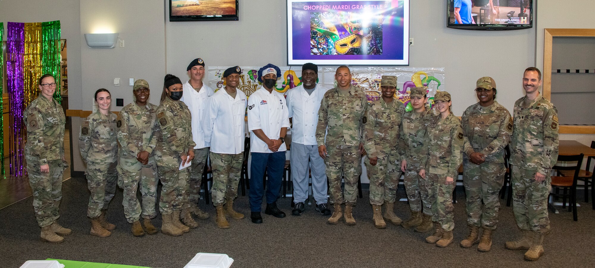 U.S. Airmen assigned to the 60th Mission Support Group participate in a Mardi Gras themed chopped competition at Travis Air Force Base, California, March 23, 2022. The 60th Mission Support Group Monarch Dining Facility hosted a cooking competition showcasing skill, speed and ingenuity. Teams of four competed to transform mystery ingredients into the main course and dessert dishes to present to a panel of judges. (U.S. Air Force photo by Heide Couch)