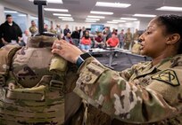 Cpt. Kim Pierre-Zamora, assistant product manager for Product Manager Soldier Protective Equipment at Program Executive Office (PEO) Soldier, demonstrates the capabilities of the modular scalable vest to an audience during a gear comparison event on Fort Belvoir, March 8. The event provided a familiarization of selected items from Project Manager Soldier Survivability and the U.S. Army Special Operations Command’s respective portfolios for a side-by-side comparison, in order to gain knowledge and identify opportunities for collaboration in the future.