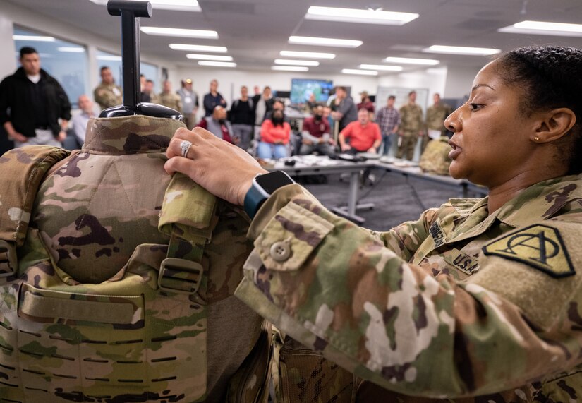 Cpt. Kim Pierre-Zamora, assistant product manager for Product Manager Soldier Protective Equipment at Program Executive Office (PEO) Soldier, demonstrates the capabilities of the modular scalable vest to an audience during a gear comparison event on Fort Belvoir, March 8. The event provided a familiarization of selected items from Project Manager Soldier Survivability and the U.S. Army Special Operations Command’s respective portfolios for a side-by-side comparison, in order to gain knowledge and identify opportunities for collaboration in the future.