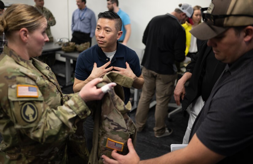 Neal Nguyen, lead systems engineer for Product Manager Soldier Protective Equipment at Program Executive Office (PEO) Soldier, explains the functionality of the Ballistics Combat Shirt during a gear comparison event on Fort Belvoir, March 8. The event provided a familiarization of selected items from Project Manager Soldier Survivability and the U.S. Army Special Operations Command’s respective portfolios for a side-by-side comparison, in order to gain knowledge and identify opportunities for collaboration in the future.